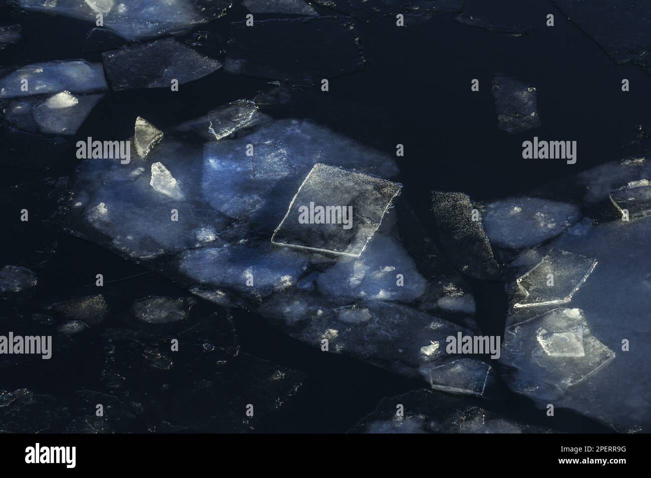 Real pretty winter ice in nature of different shapes in dark water ...