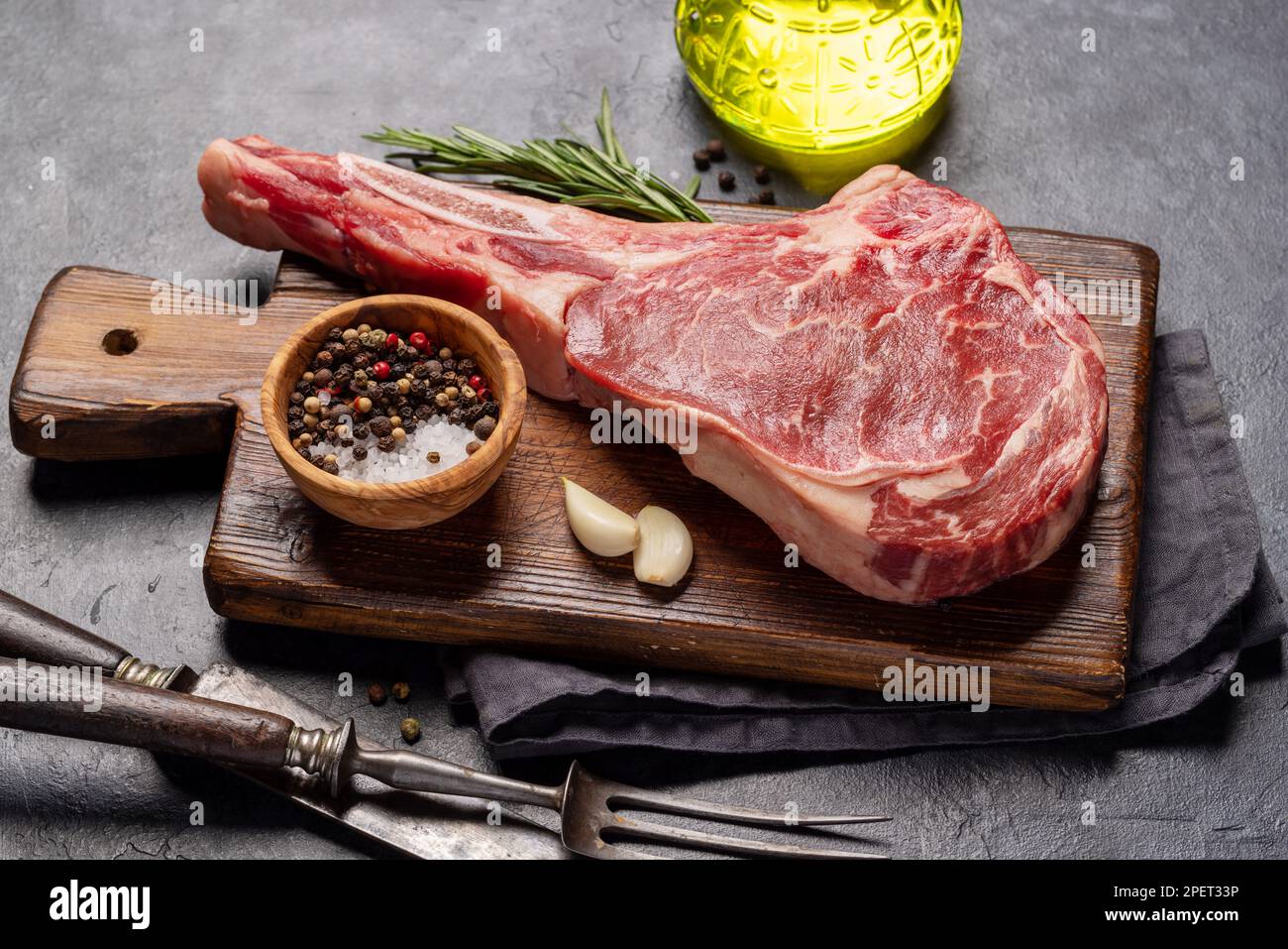 Raw Tomahawk beef steak and spices. Ready for grilling Stock Photo