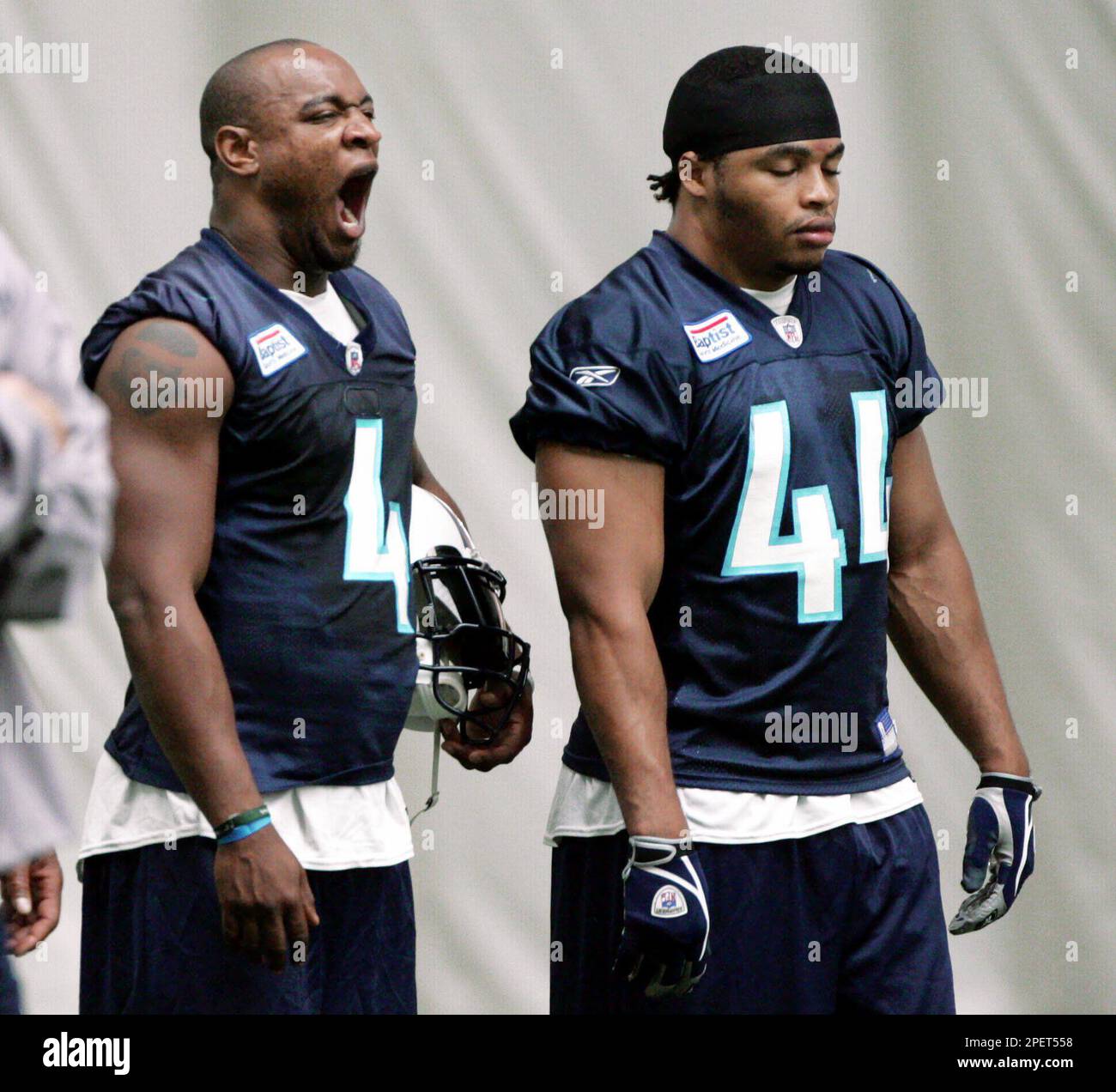 Tennessee Titans rookie running back Jarrett Payton (4) yawns as rookie  fullback Troy Fleming rests his eyes during a morning training camp workout  on Monday, Aug. 2, 2004 in Nashville, Tenn. (AP