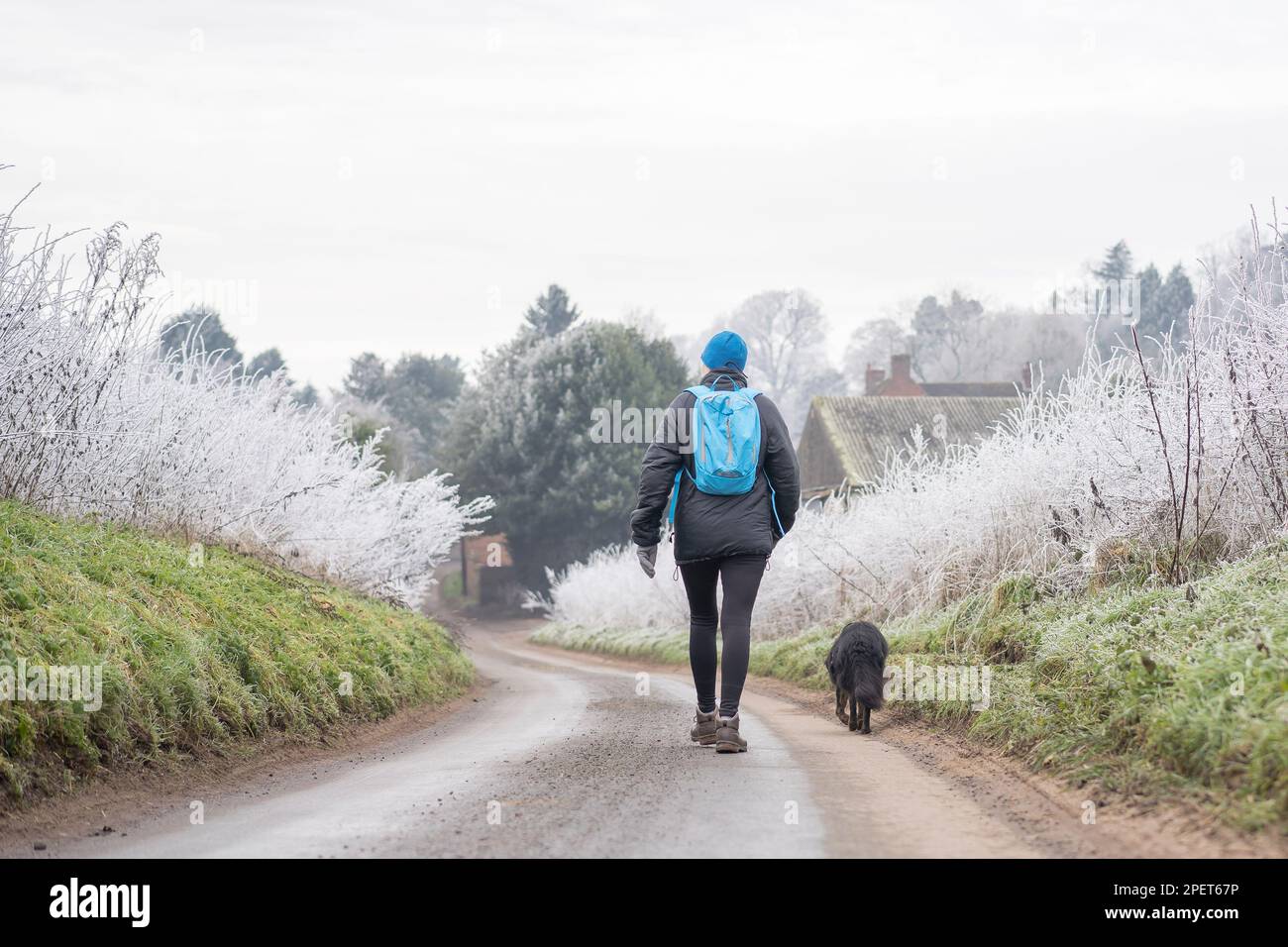 Woman walking down country lane hi-res stock photography and images - Alamy