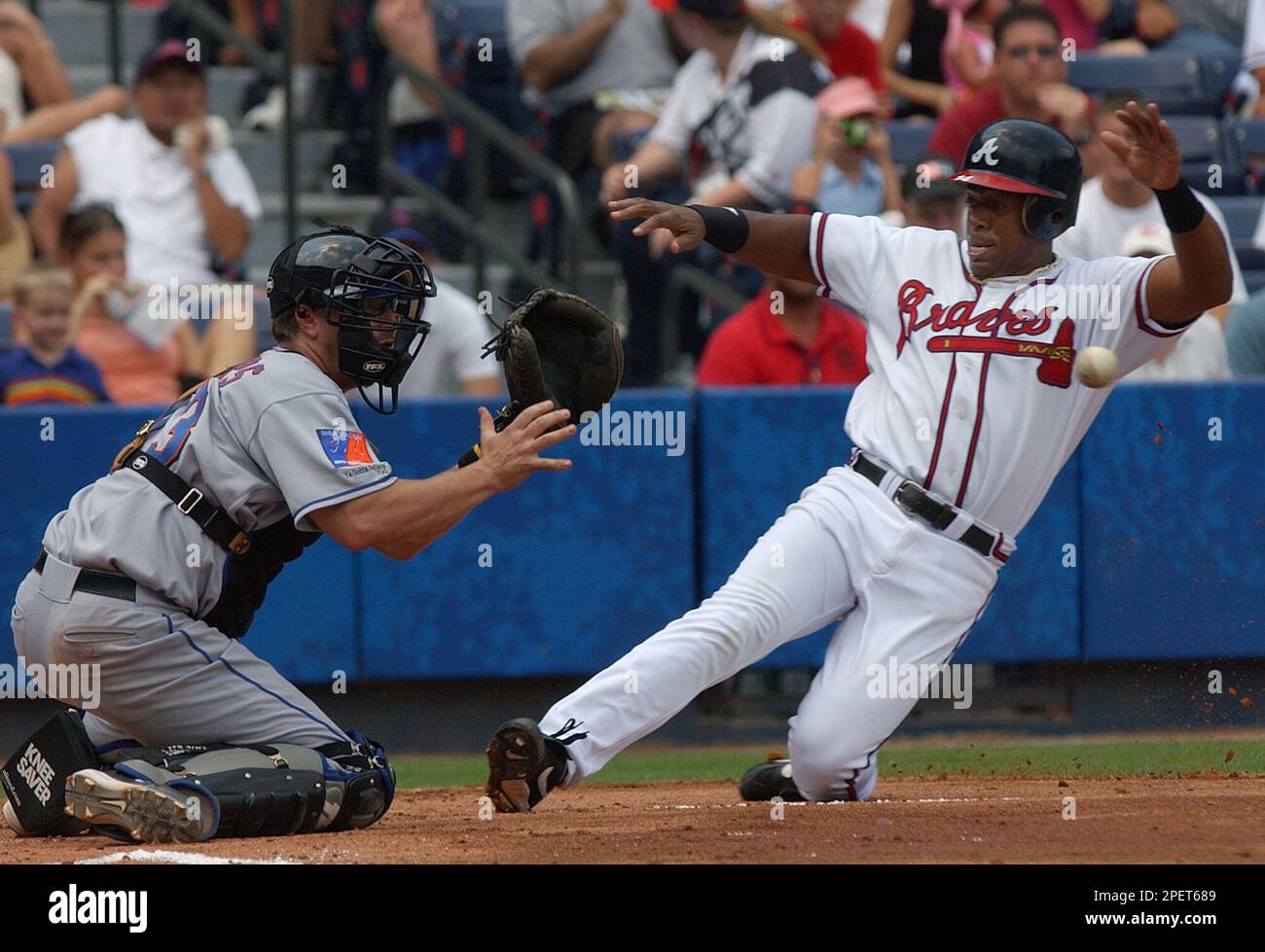 New York mets catcher Jason Phillips prepares to tag out Atlanta Braves' Julio  Franco who was trying to score on a Eli Marrero single in the first inning  Sunday, Aug. 1, 2004. (