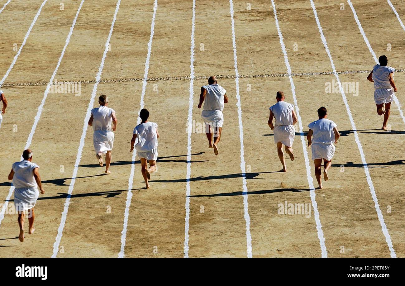 Barefoot runners wearing tunics take part in a footrace in the ancient ...