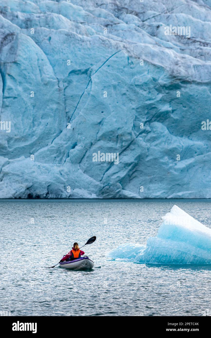 Young Woman Kayaking Mosevatnet Lake with Folgefonna Glacier in the  background, Visiting Norway Stock Photo - Alamy