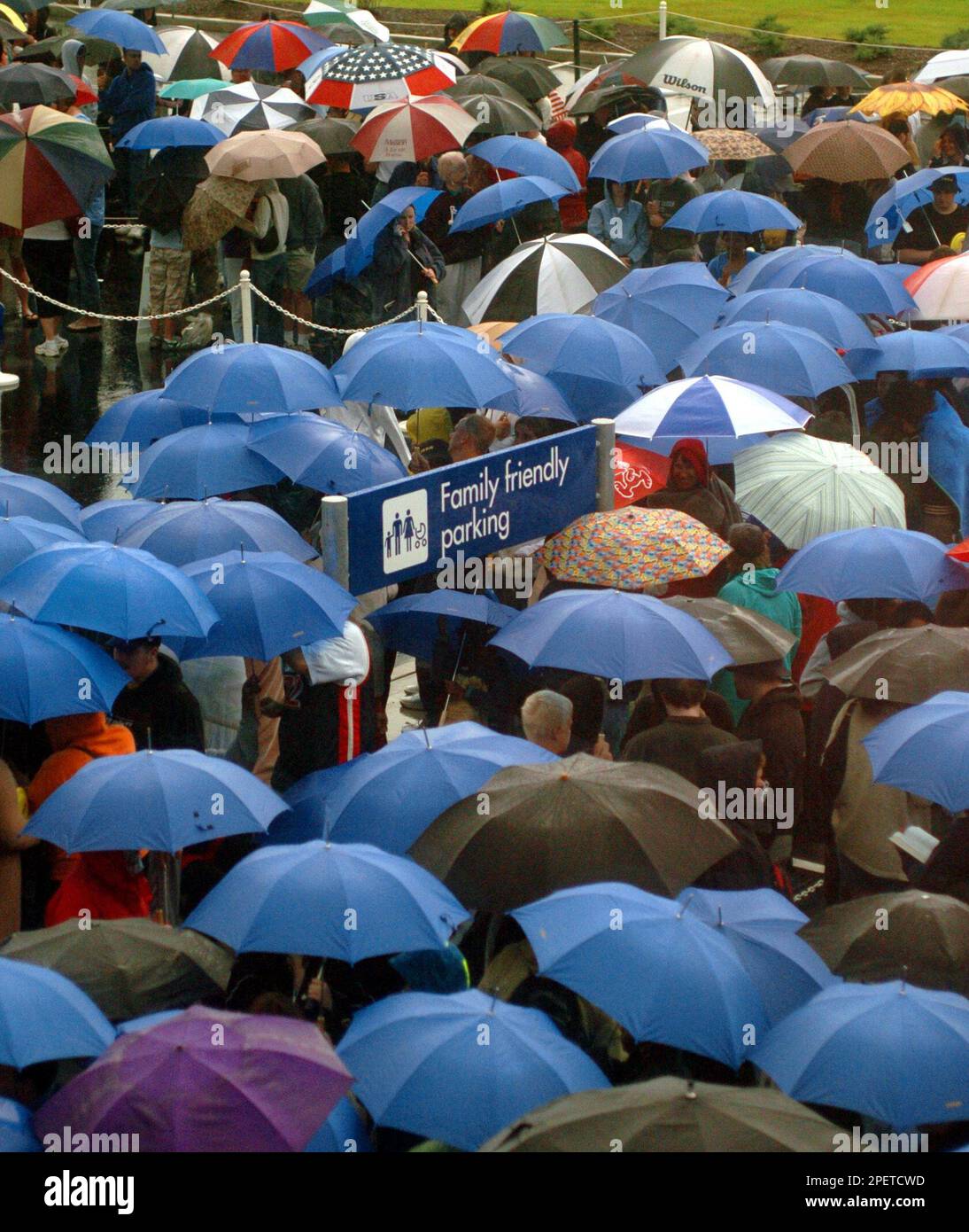 Members of the public line up under umbrellas outside the Ikea