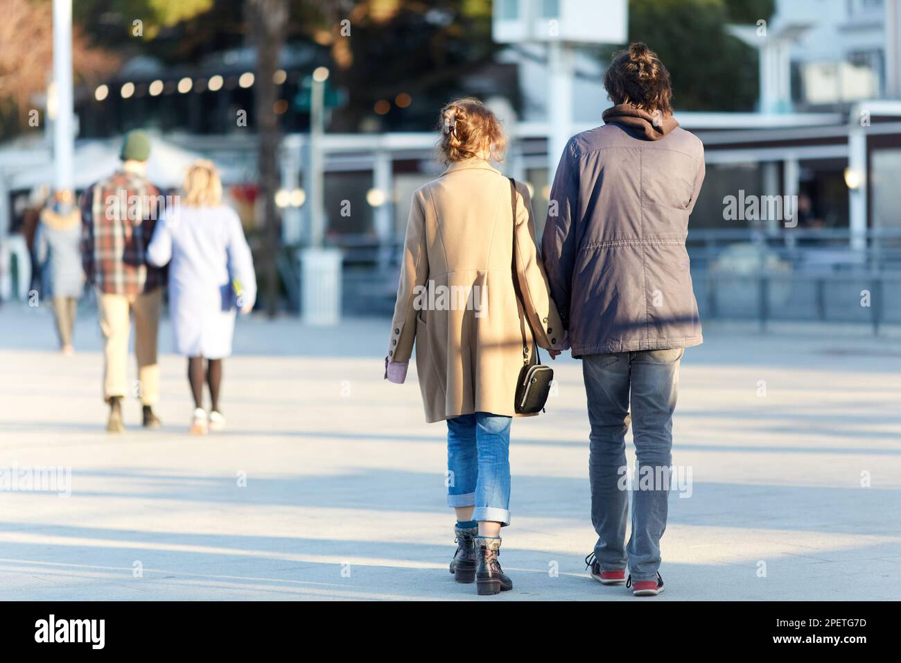 Couple arm shoulder walking hi-res stock photography and images - Alamy