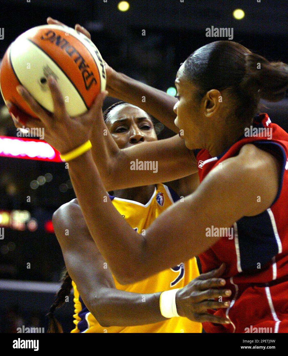 Los Angeles Sparks' Lisa Leslie, left, guards Houston Comets' Tina