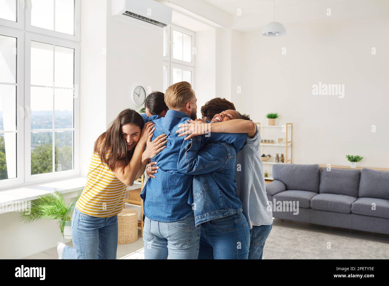 Group of happy, joyful diverse people meeting, hugging each other and ...
