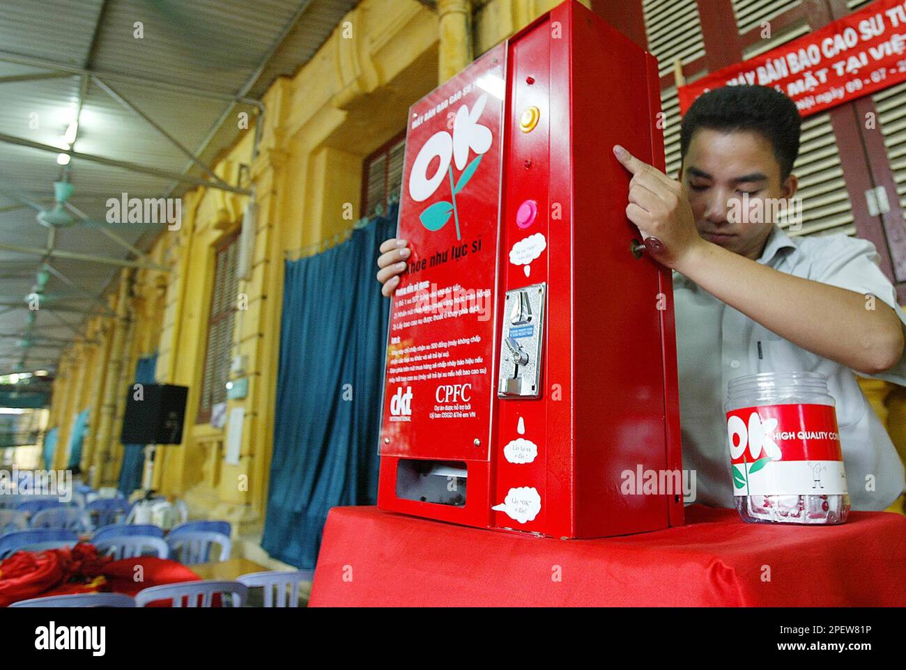 A Vietnamese worker sets up Vietnam's first condom vending machine for