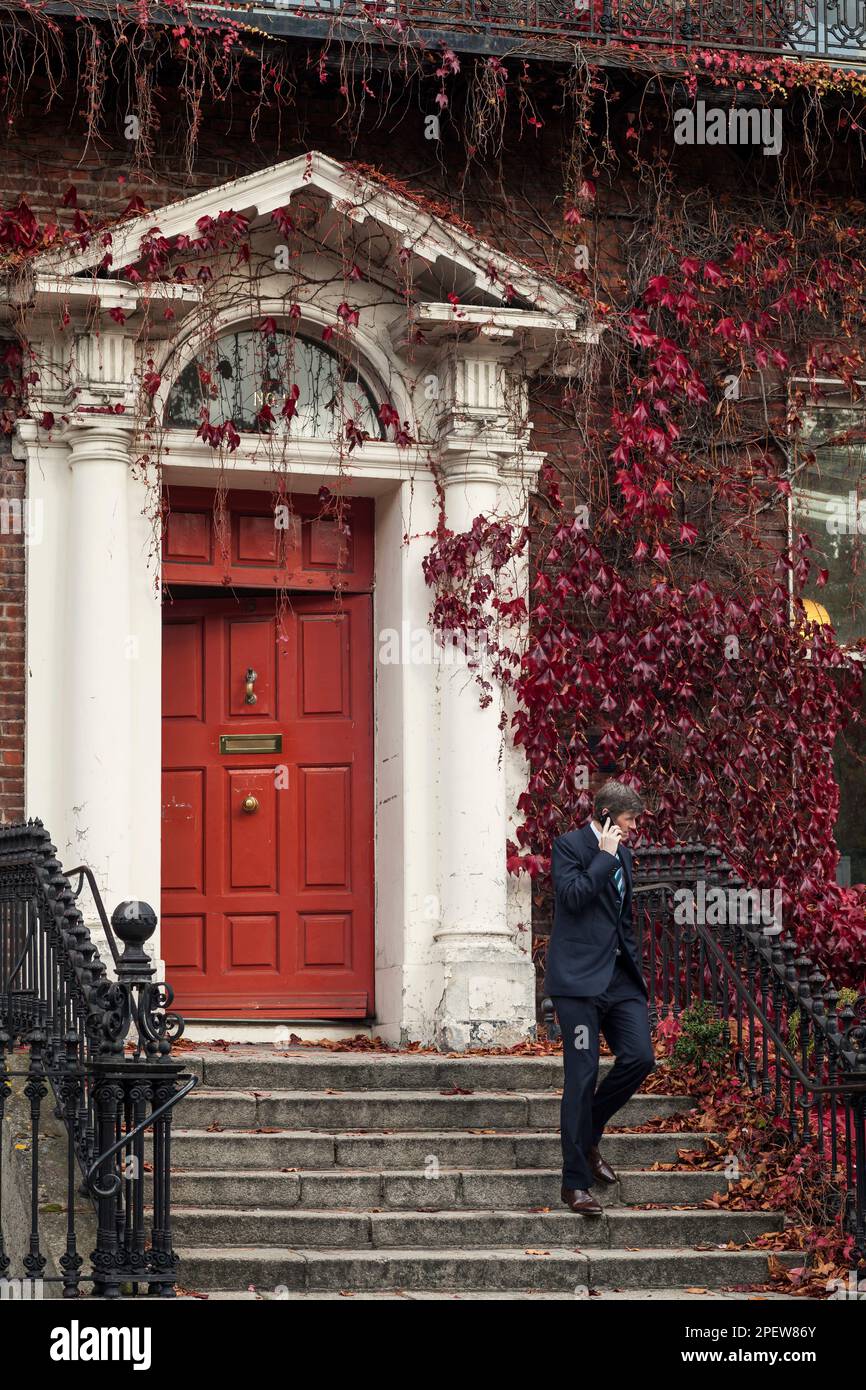 Executive leaving a Victorian Style house in Dublin Stock Photo