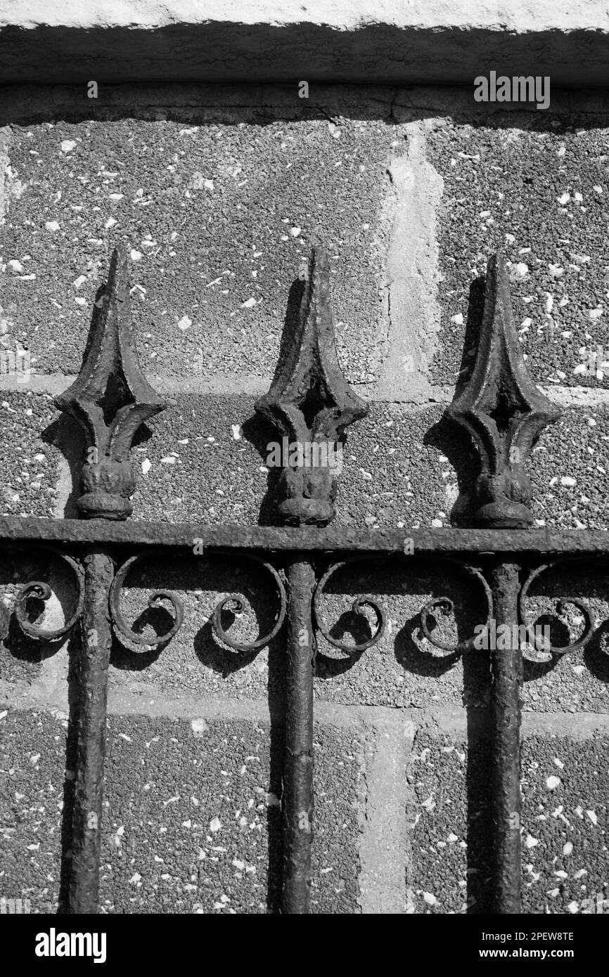 A vintage and fancy metal gate with rusted decorations and security ...