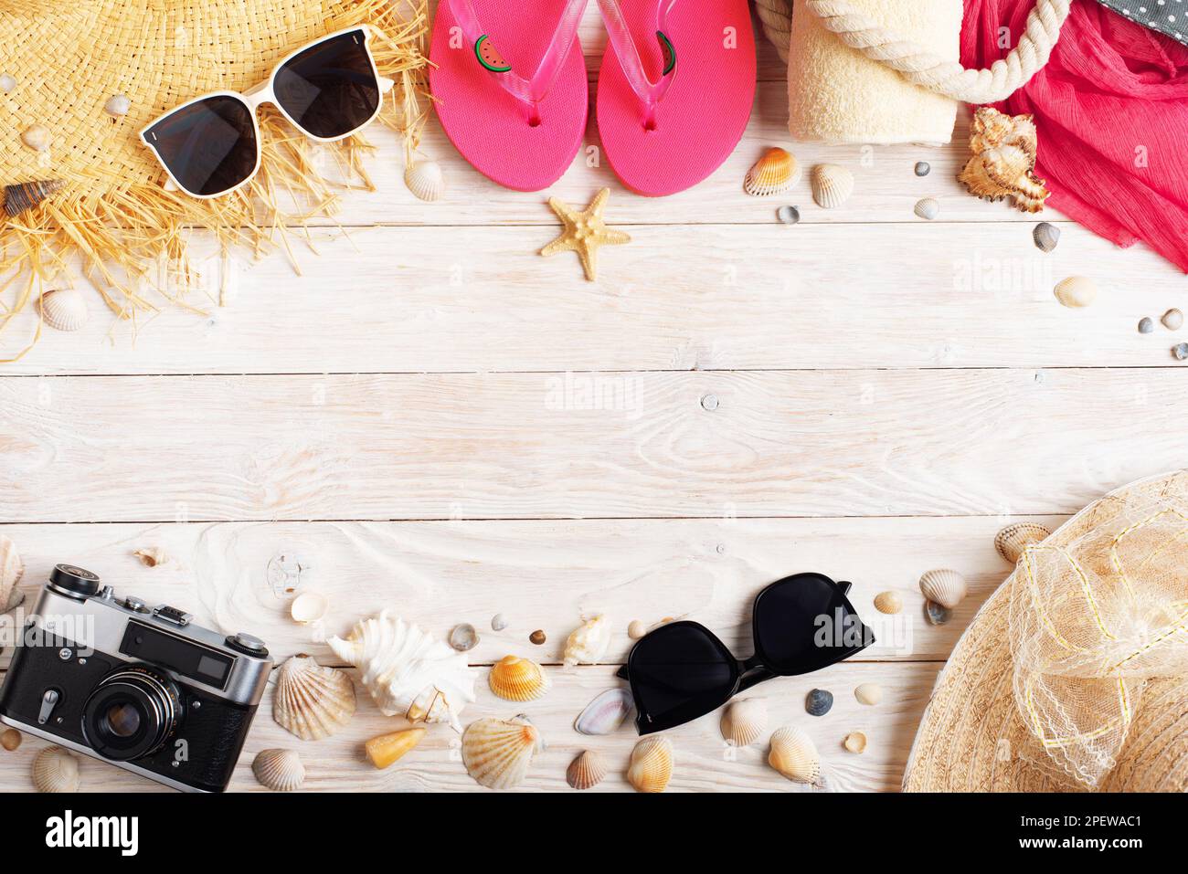 Camera straw hat sunglasses flip flops on white wooden background Stock ...