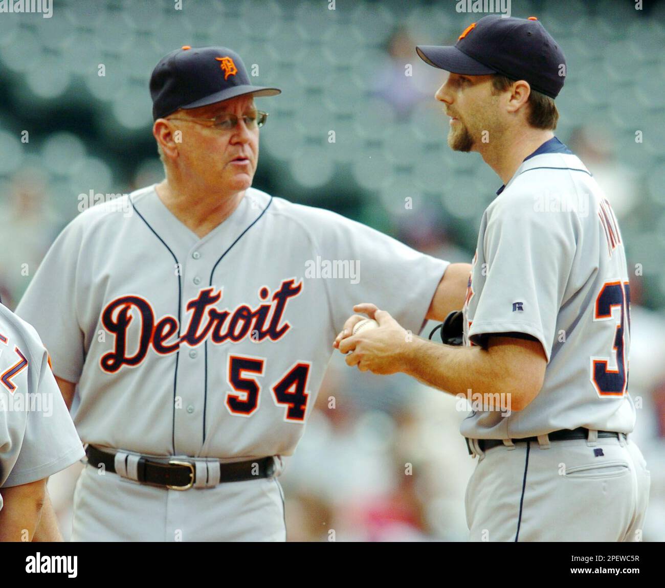 Detroit Tigers pitching coach Bob Cluck, left, reaches out to