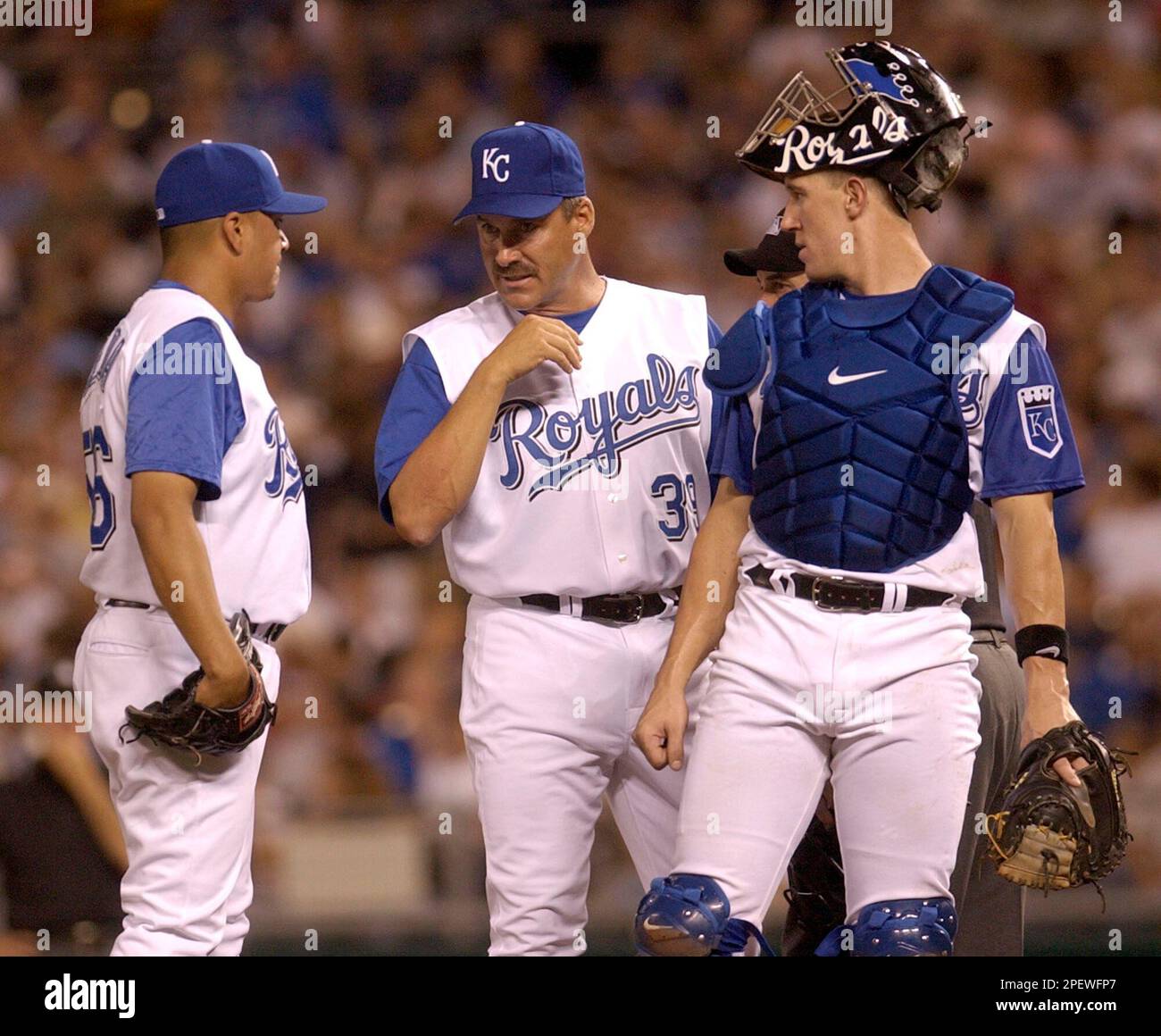 Kansas City Royals pitching coach Mike Mason, center, meets with pitcher  Jamie Cerda, left, and catcher John Buck after Cerda loaded the bases in  the ninth inning against the Baltimore Orioles Thursday,