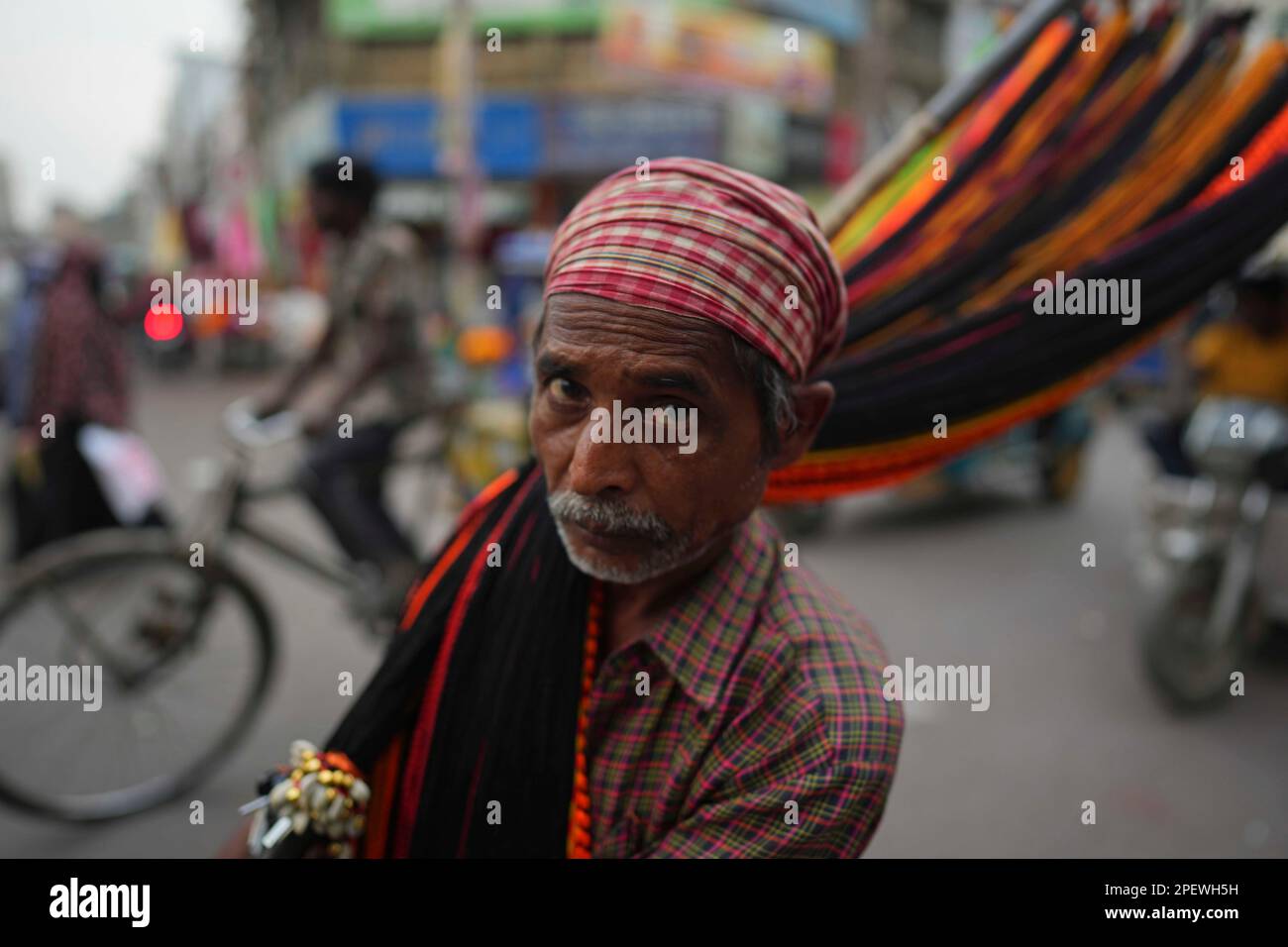 A vendor displays his ware in Prayagraj, in the northern Indian state ...