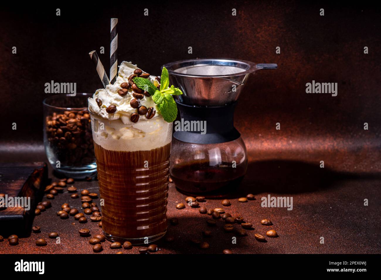 Iced coffee in tall glass. One sweet cold latte with whipped cream, with  chemex coffee maker on dark brown background copy space Stock Photo - Alamy