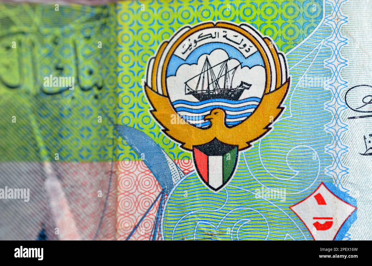 The coat of arms and flag of Kuwait closeup from the obverse side of