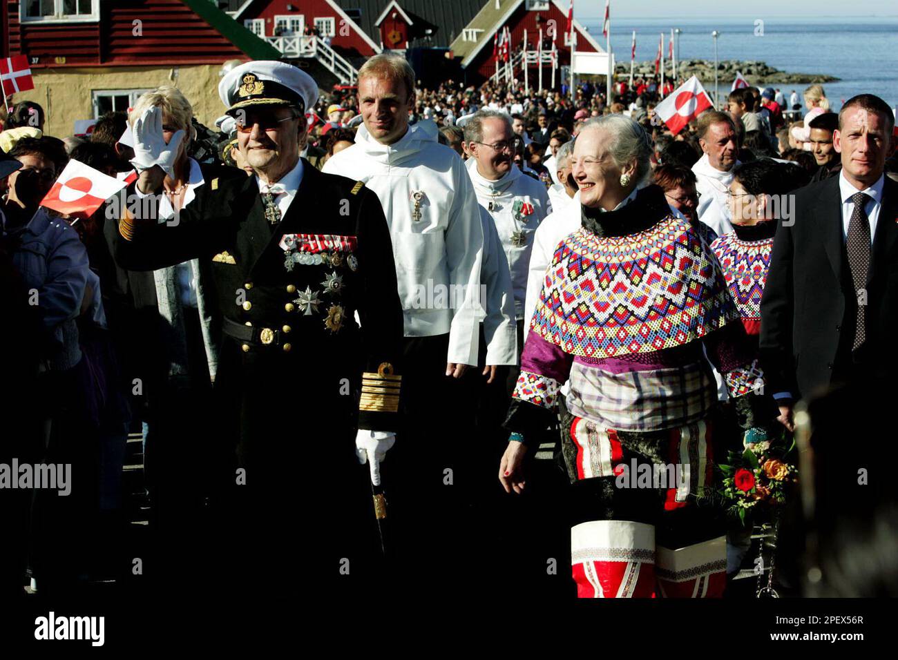 People wave Greenland and Danish flags as gather to cheer as Queen