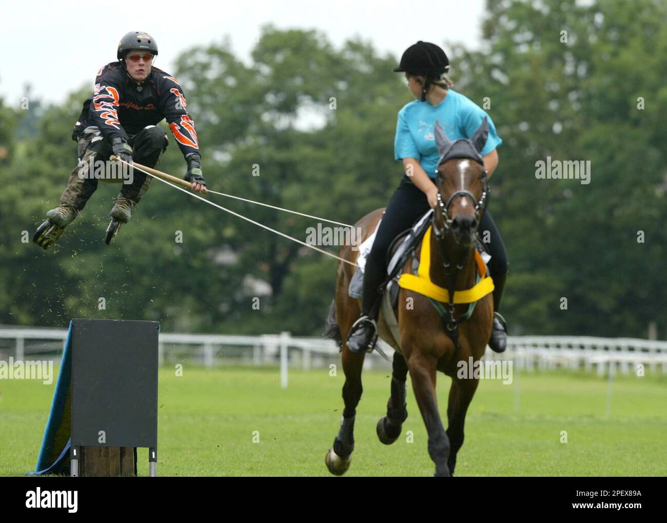 Dani Meier, left, is pulled across a ramp by Sara Forster on the horse