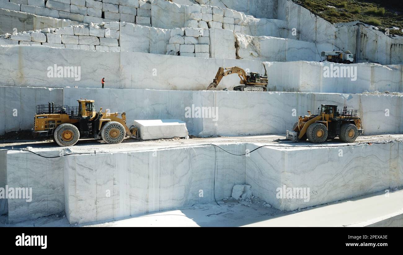 Heavy machines working at a huge marble quarry in Europe. Transporting