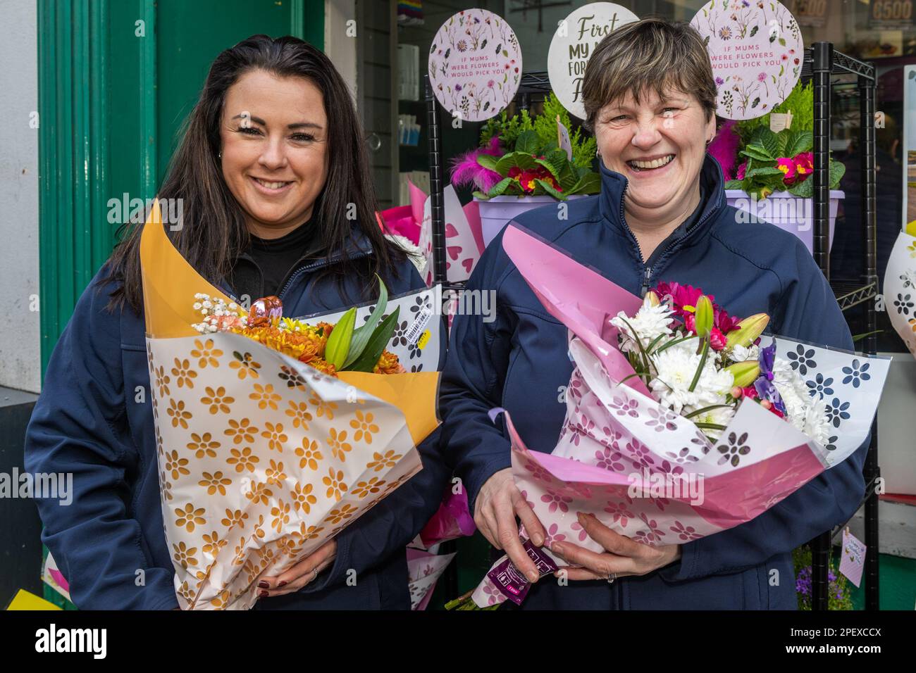 Clonakilty, West Cork, Ireland. 16th Mar, 2023. Preparations are well under way for St. Patrick's Day in the West Cork town of Clonakilty. Sam Minihane and Deidre Dulea of Gala Clonakilty show off some of the St. Patrick's Day themed flower bouquets. Credit: AG News/Alamy Live News Stock Photo