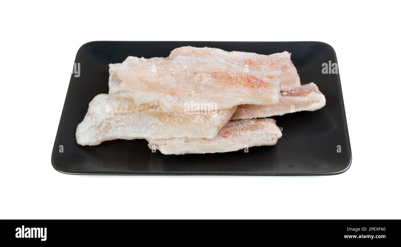 Frozen Fish on Black Isolated, White Cod Fillet, Iced Hake Filet, Frozen Pollock Meat on White Background Stock Photo
