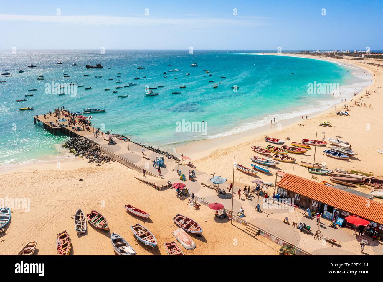 Pier and boats on turquoise water in city of Santa Maria, island of Sal, Cape Verde Stock Photo