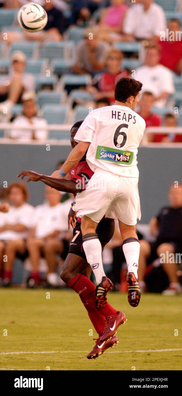 New England Revolution's Jay Heaps (6) leaps over Dallas Burn's Eddie ...