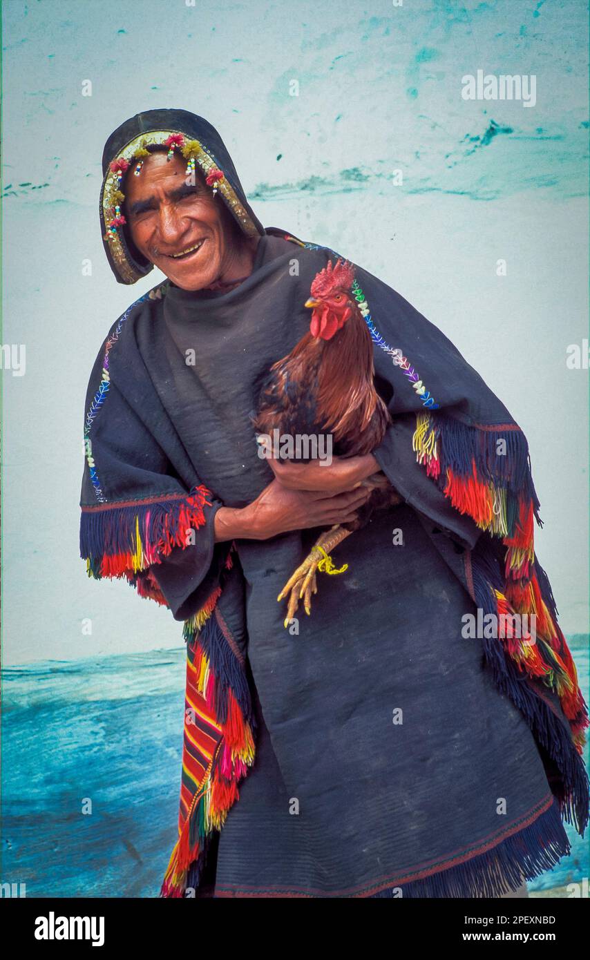 Bolivia, Tarabuco. Quichua man with fighting rooster. Stock Photo