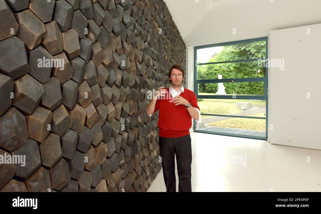 The Danish Icelandic artist Olafur Eliasson poses in front of one of