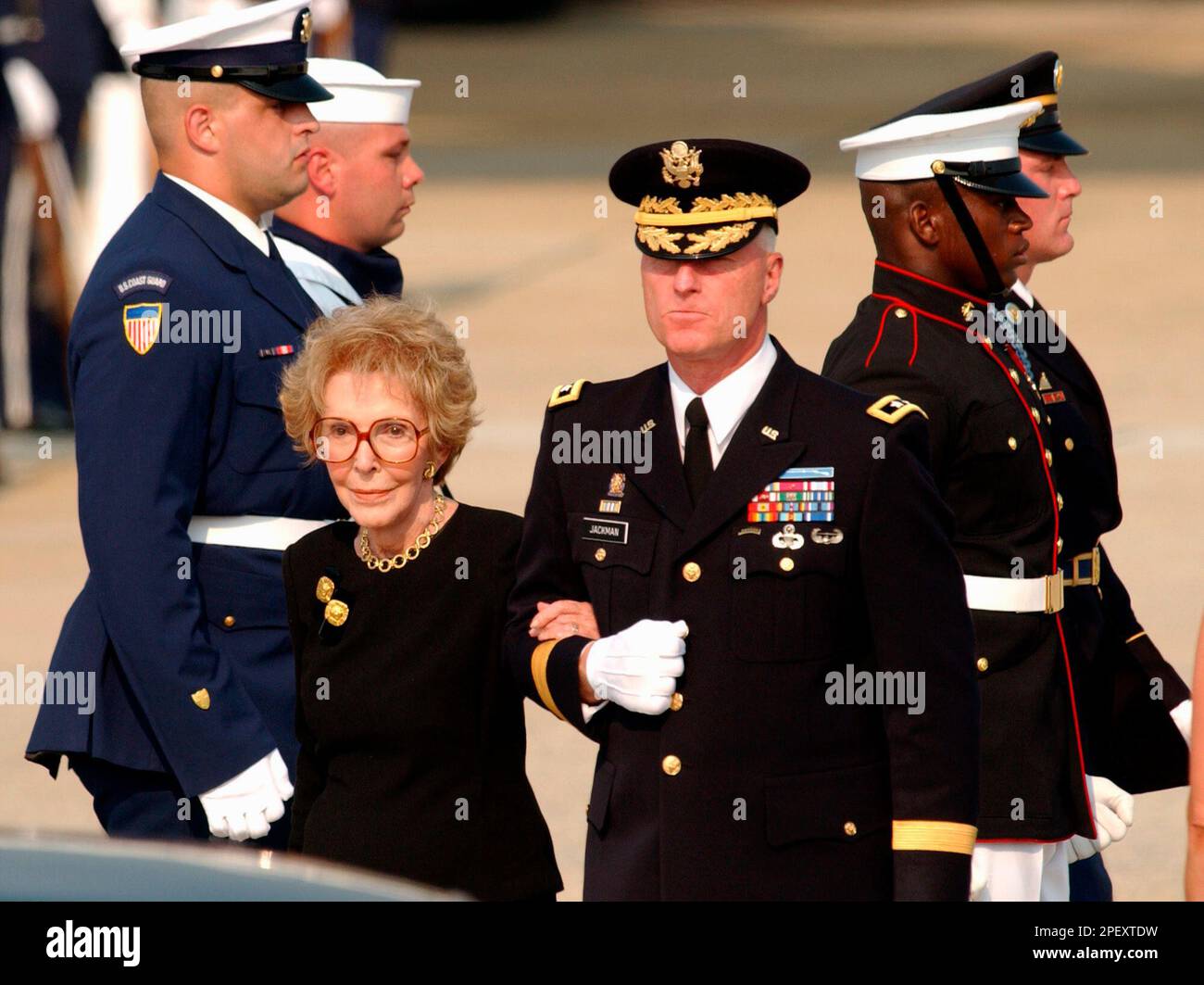 Nancy Reagan is escorted by Army Maj. Gen. Galen B. Jackman as the body ...