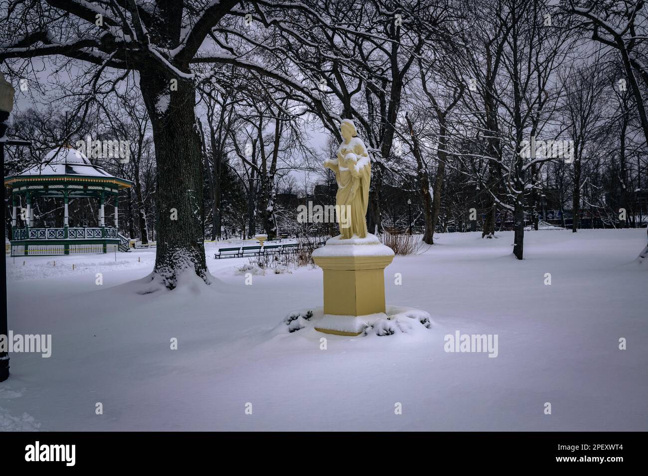 The Statue Ceres, goddess of agriculture, grain crops and fertility in Halifax Public Gardens National Historic Site of Canada in the depths of winter Stock Photo