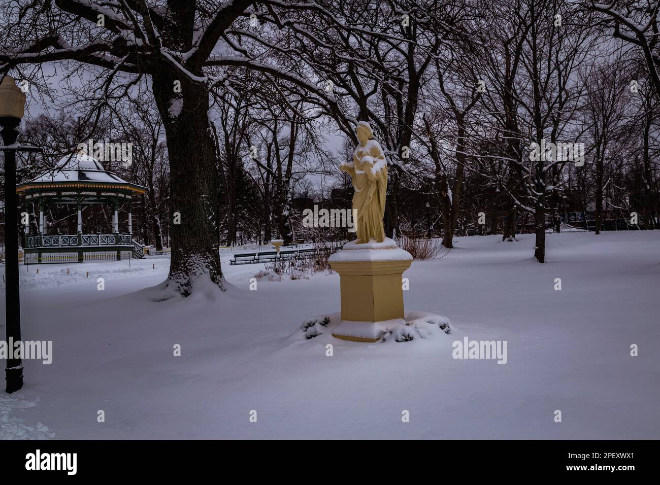 The Statue Ceres, goddess of agriculture, grain crops and fertility in Halifax Public Gardens National Historic Site of Canada in the depths of winter Stock Photo