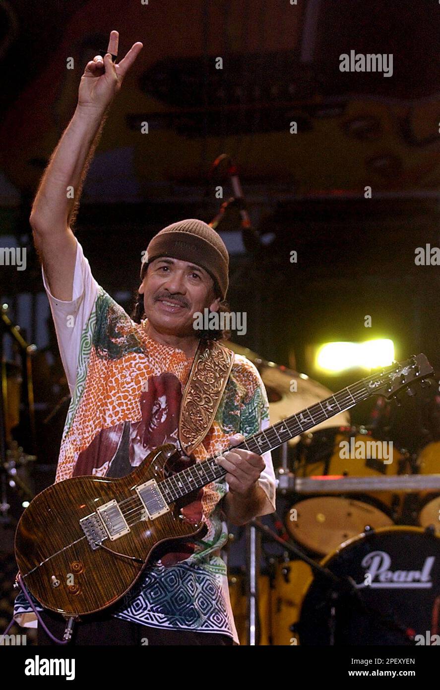 Carlos Santana gestures the peace sign to fans following his