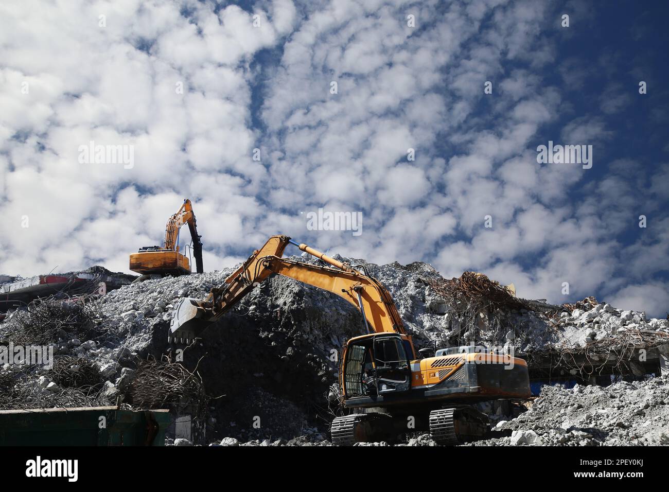Excavator at demolition work with hydraulic breaker hammer. Excavator