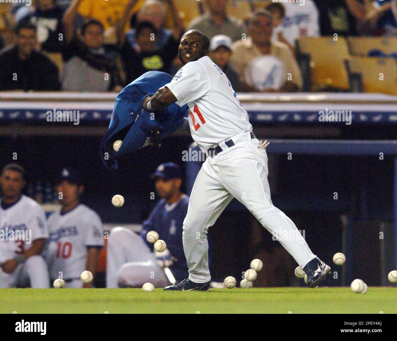 Los Angeles Dodgers' Milton Bradley throws a bag of baseballs onto the