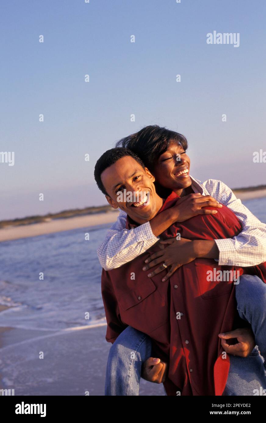 Romantic african-American couple having fun in the summertime on the beach Stock Photo