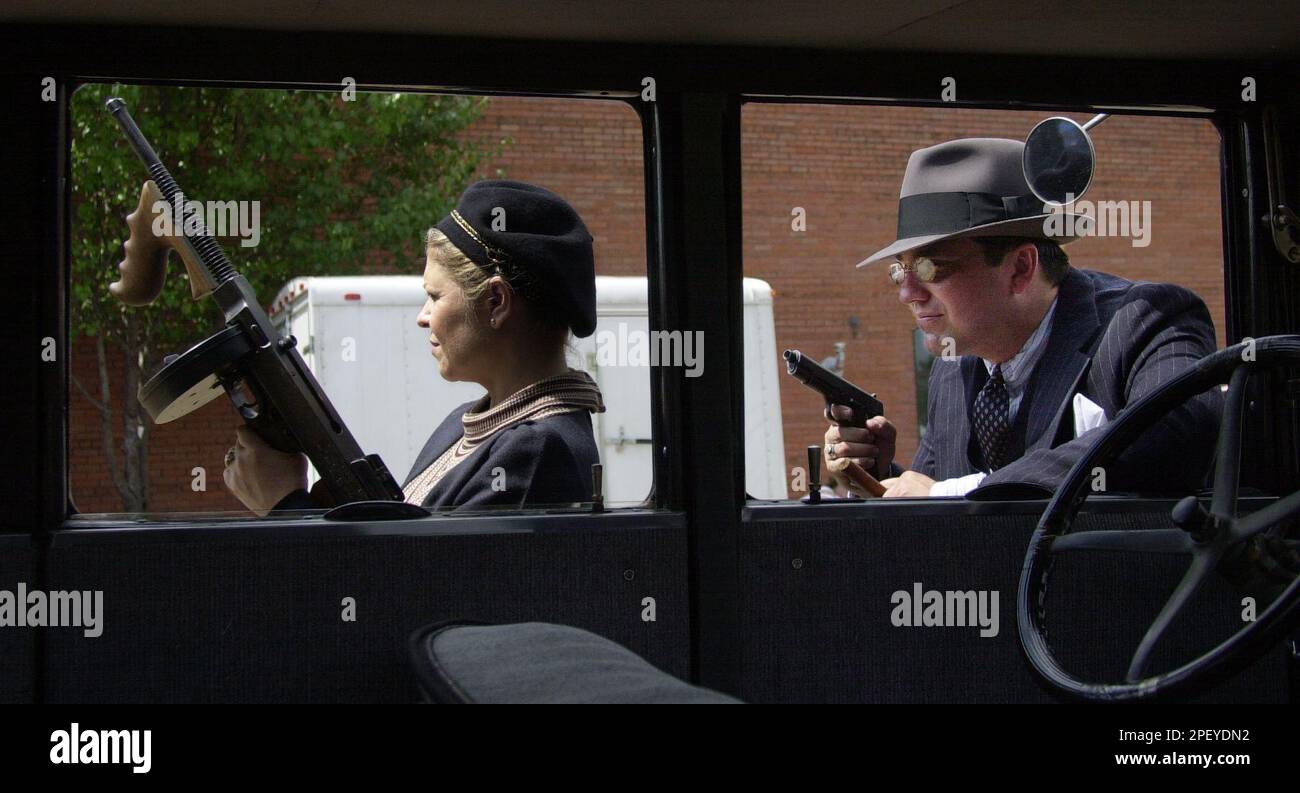 Michelle Groves, left, and Roger Groves dress as Bonnie Parker and