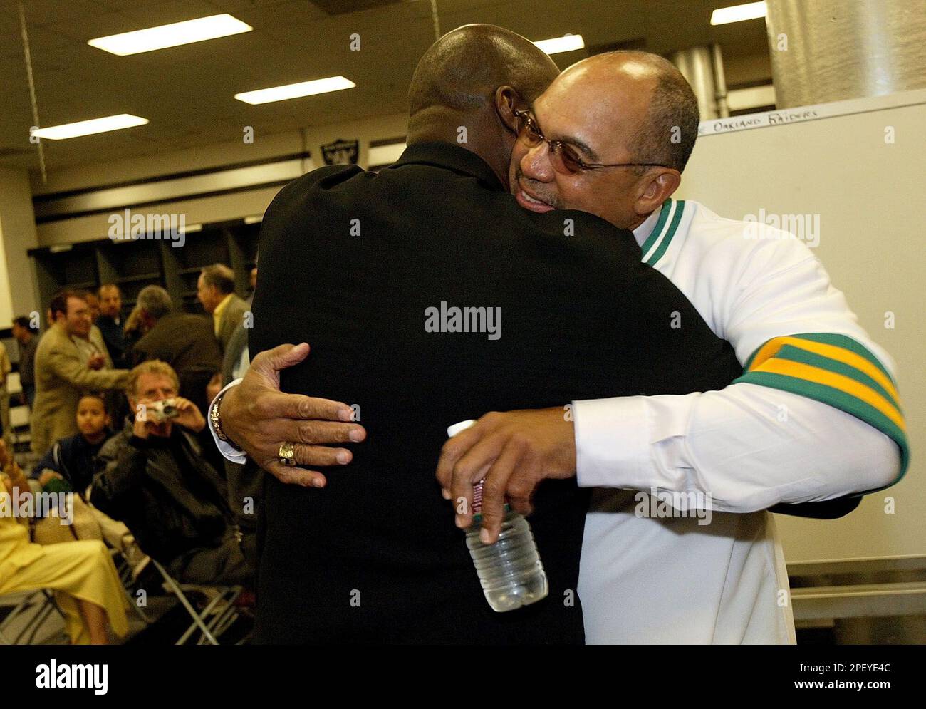 Reggie Jackson, right, hugs former teammate Dave Stewart at a news  conference to retire his number with the Oakland Athletics before the  Athletics played the Kansas City Royals in Oakland, Calif. on