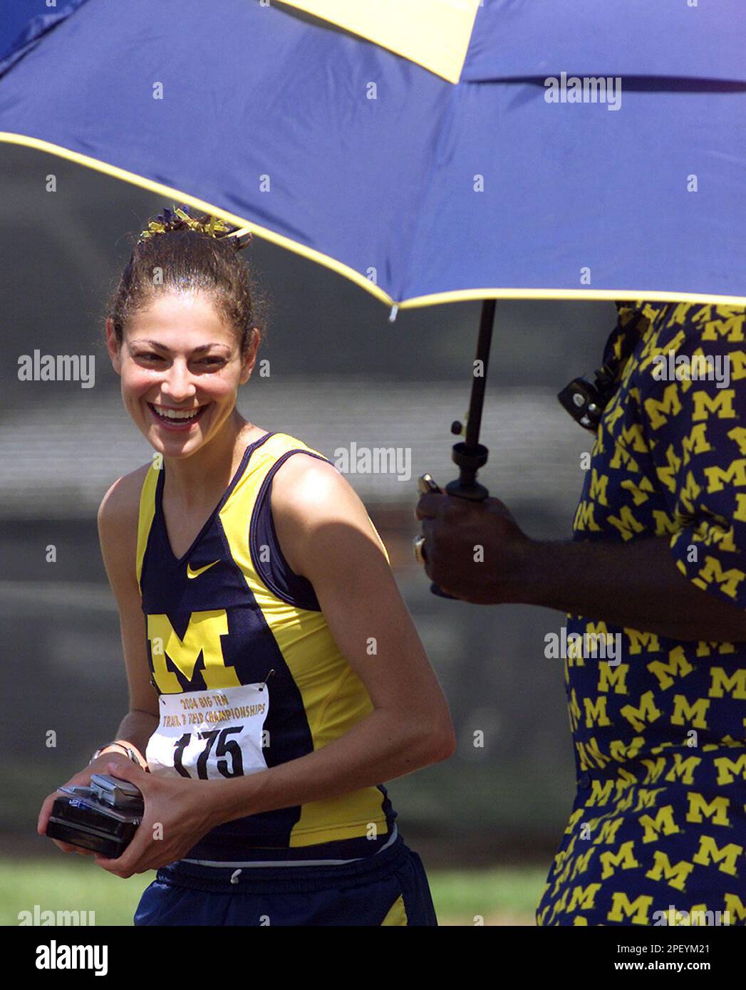 Lindsey Gallo of Michigan talks to one of her coaches Sunday, May 16, 2004, after winning the 1,500 and 800-meter runs at the the Big Ten Conference Mens and Womens Track and Field Championships in West Lafayette, Ind. (AP Photo/Journal and Courier, Michael Heinz) Stock Photo
