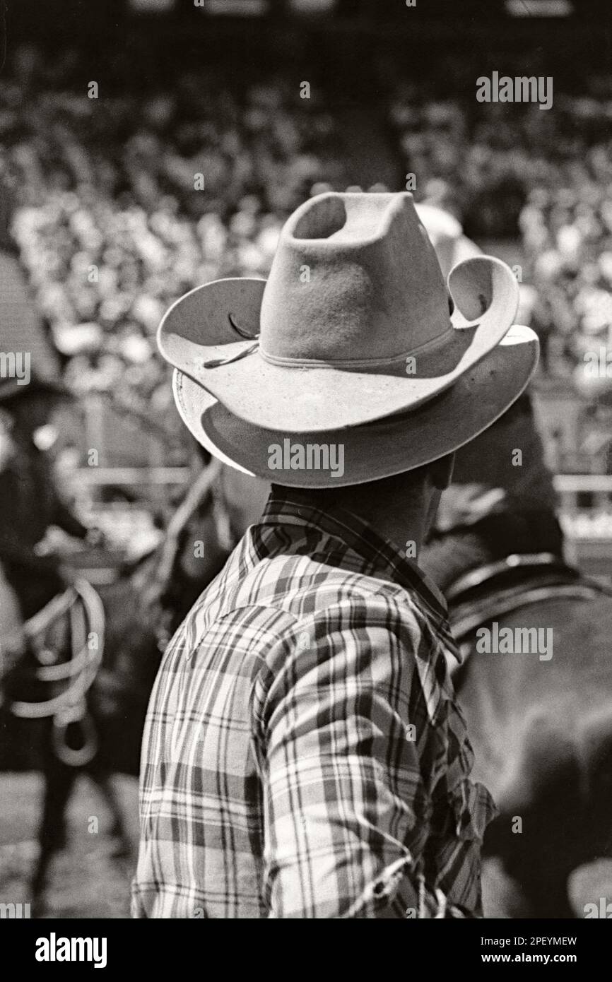 Vintage monochrome portrait of a rodeo cowboy wearing two cowboy hats at the Calgary Stampede Rodeo, circa 1980 Stock Photo