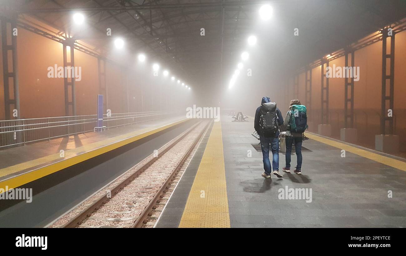 Railway station platform Boryspil Airport in the fog with two tourists figures Stock Photo