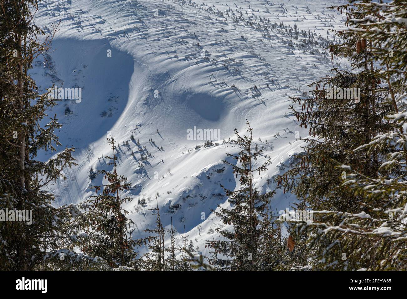 Mountain range and avalanche dangerous terrain in snowy mountains ...