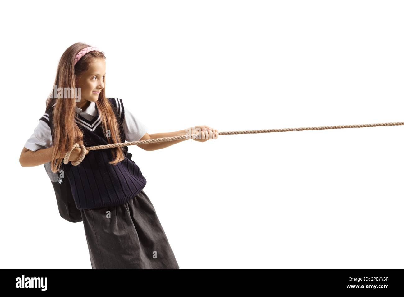 Schoolgirl pulling a rope isolated on white background Stock Photo - Alamy
