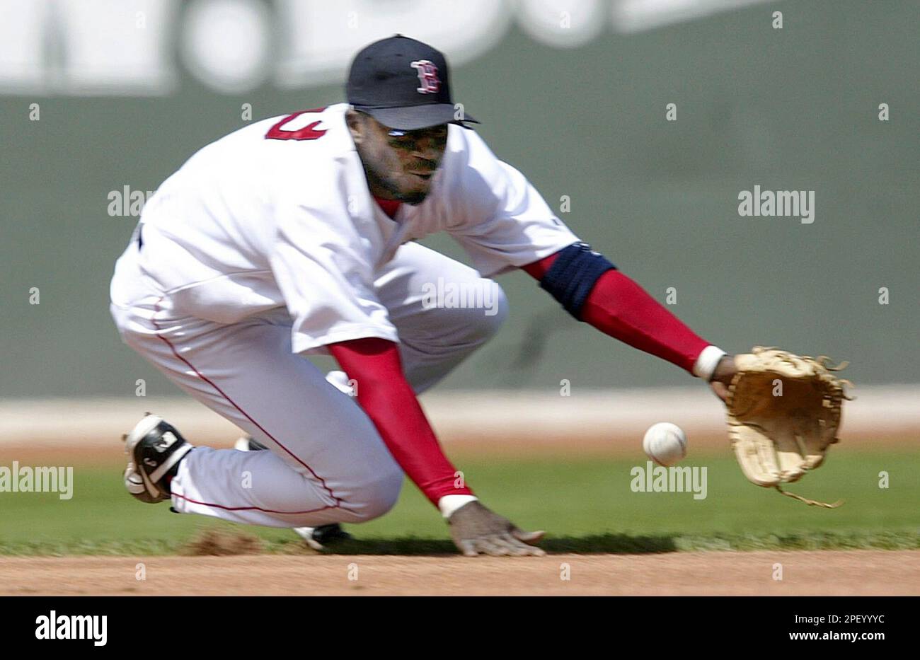 Boston Red Sox shortstop Pokey Reese has trouble tracking down a ground  ball hit by Kansas City Royals batter Ken Harvey in the third inning at  Fenway Park in Boston, Saturday, May