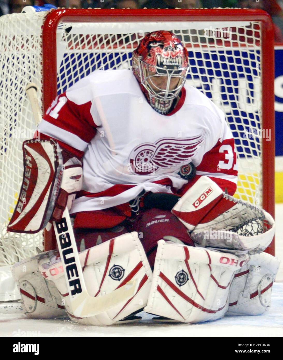 Detroit Red Wings goalie Curtis Joseph makes a save during second period  NHL playoff action against the Calgary Flames in Calgary Monday, May 3,  2004. (AP Photo/Jeff McIntosh Stock Photo - Alamy