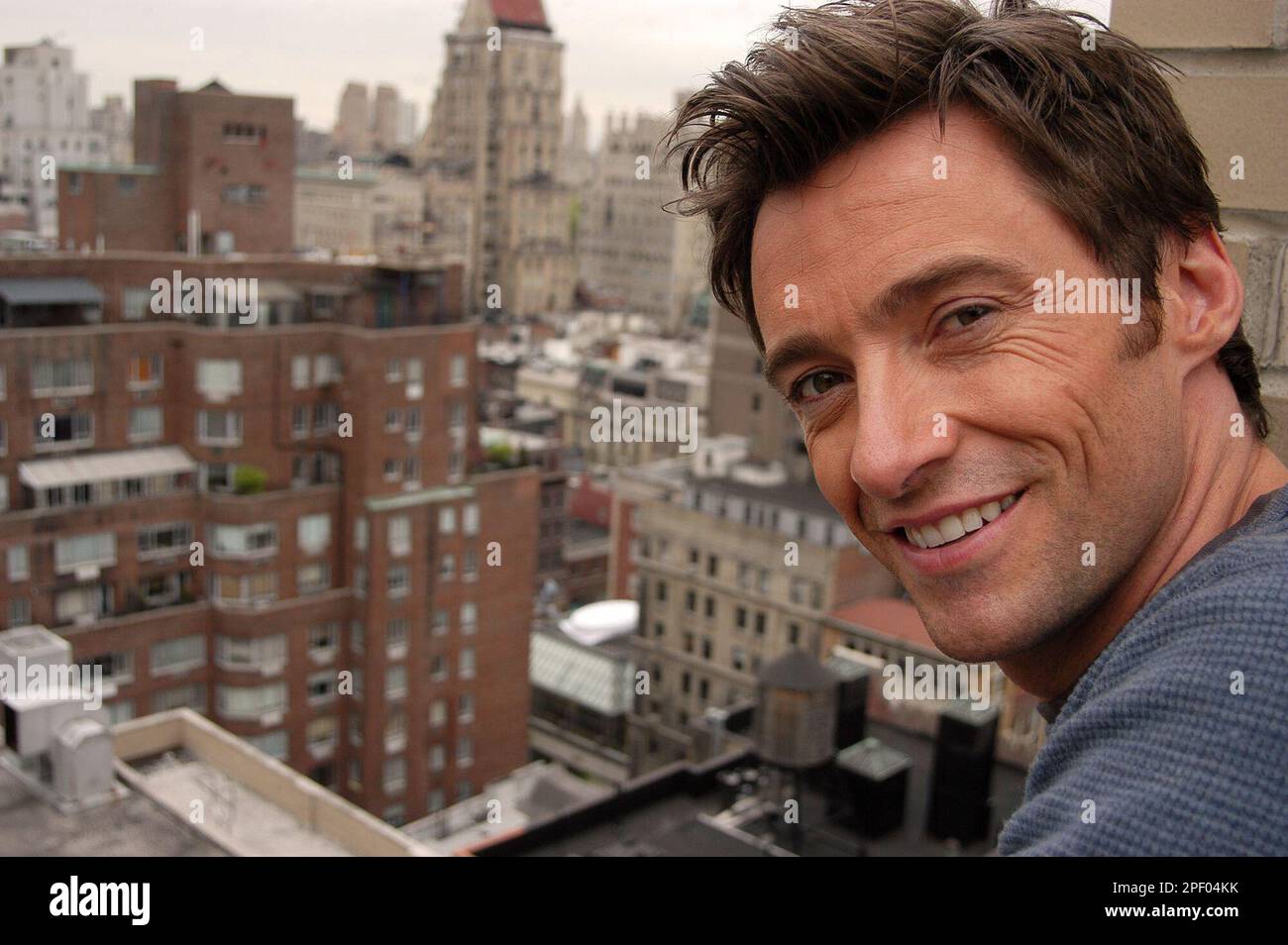 Actor Hugh Jackman poses for A photograph on a balcony at the Regency