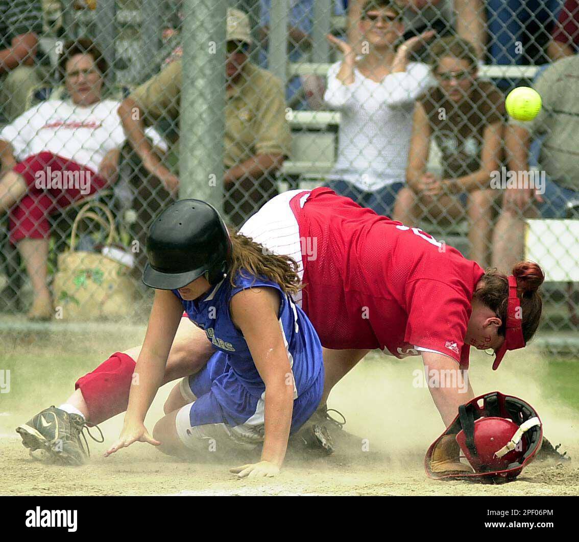 Calvin's JoAnn Griffin, left, slides into home plate on a passed ball