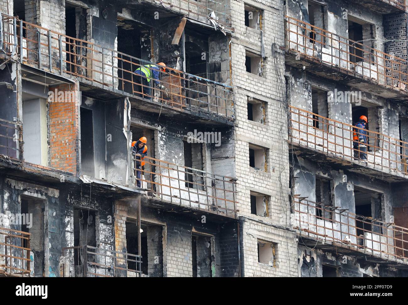Workers dismantle a multi-storey apartment block, which was destroyed in the course of Russia-Ukraine conflict, in Mariupol, Russian-controlled Ukraine, March 16, 2023. REUTERS/Alexander Ermochenko Stock Photo