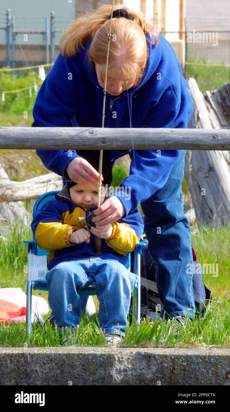 Nora Mosher, of Bremerton, Wash., helps her son Aaron, 2, set up his fishing  pole at Otto Jarstadt Park in Gorst, Wash., Saturday, April 24, 2004. In  this annual opening day event