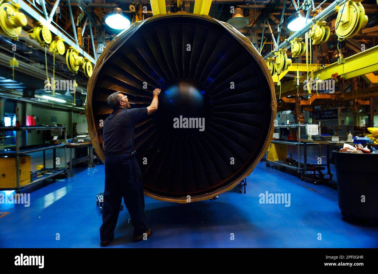 General Electric airplane engine technichian Merle Hawkins inspects a